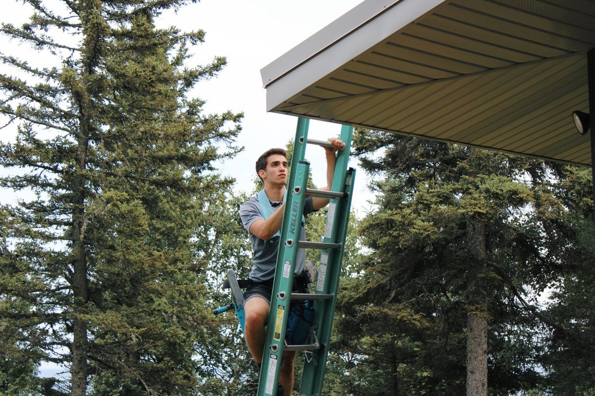 Crew member on the ladder at a soffit