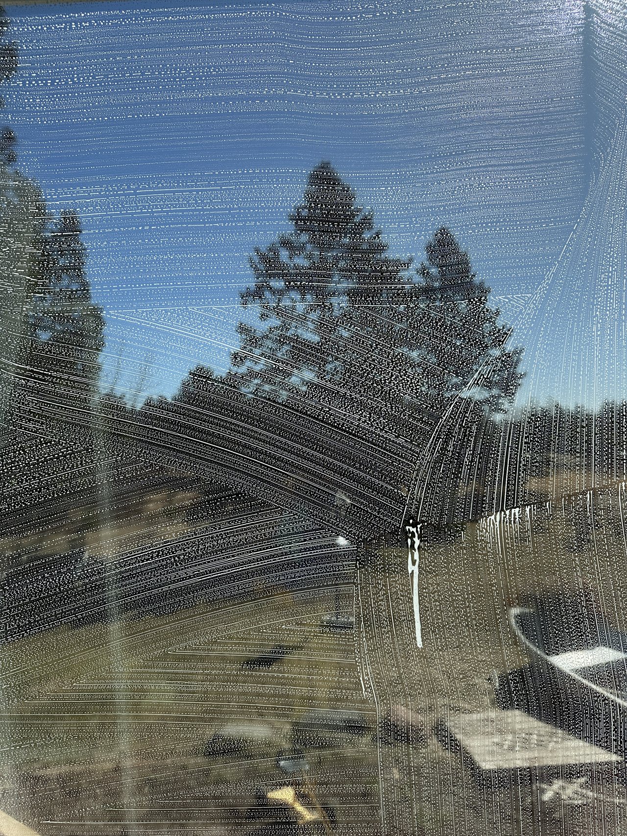 Soap scrub pattern working across a customer's window mid-clean